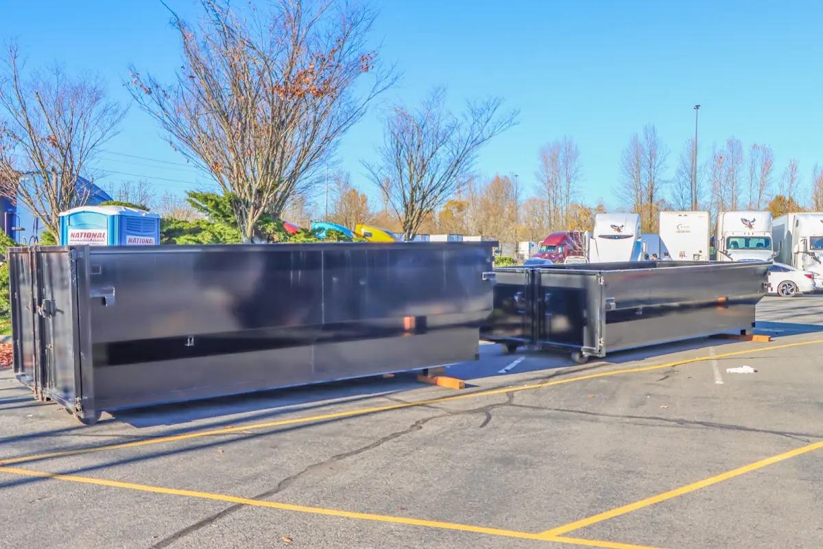 Professional dumpster rental service with roll-off container on residential driveway in Rifle